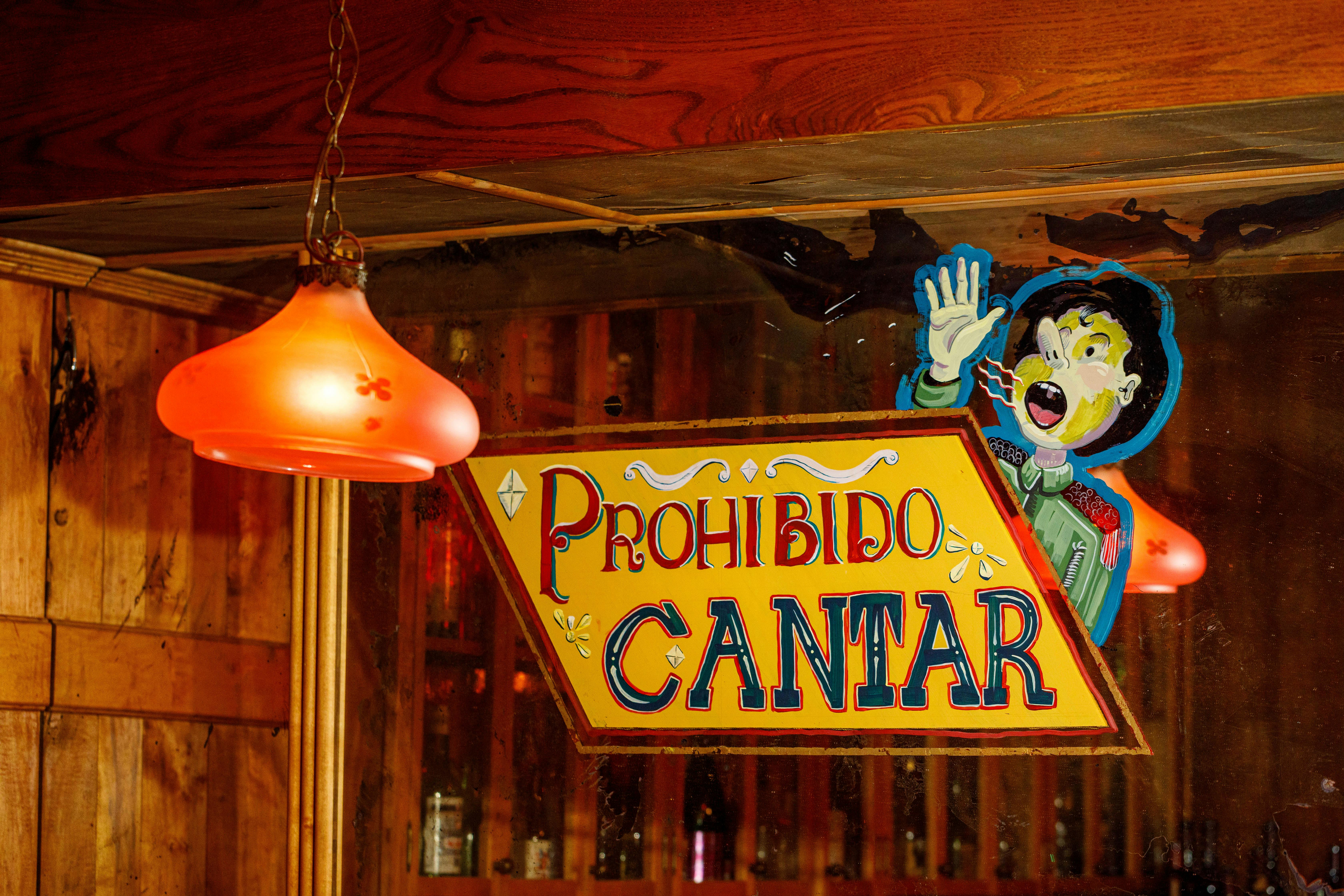 Prohibido Cantar painted glass at Bar Isabel
