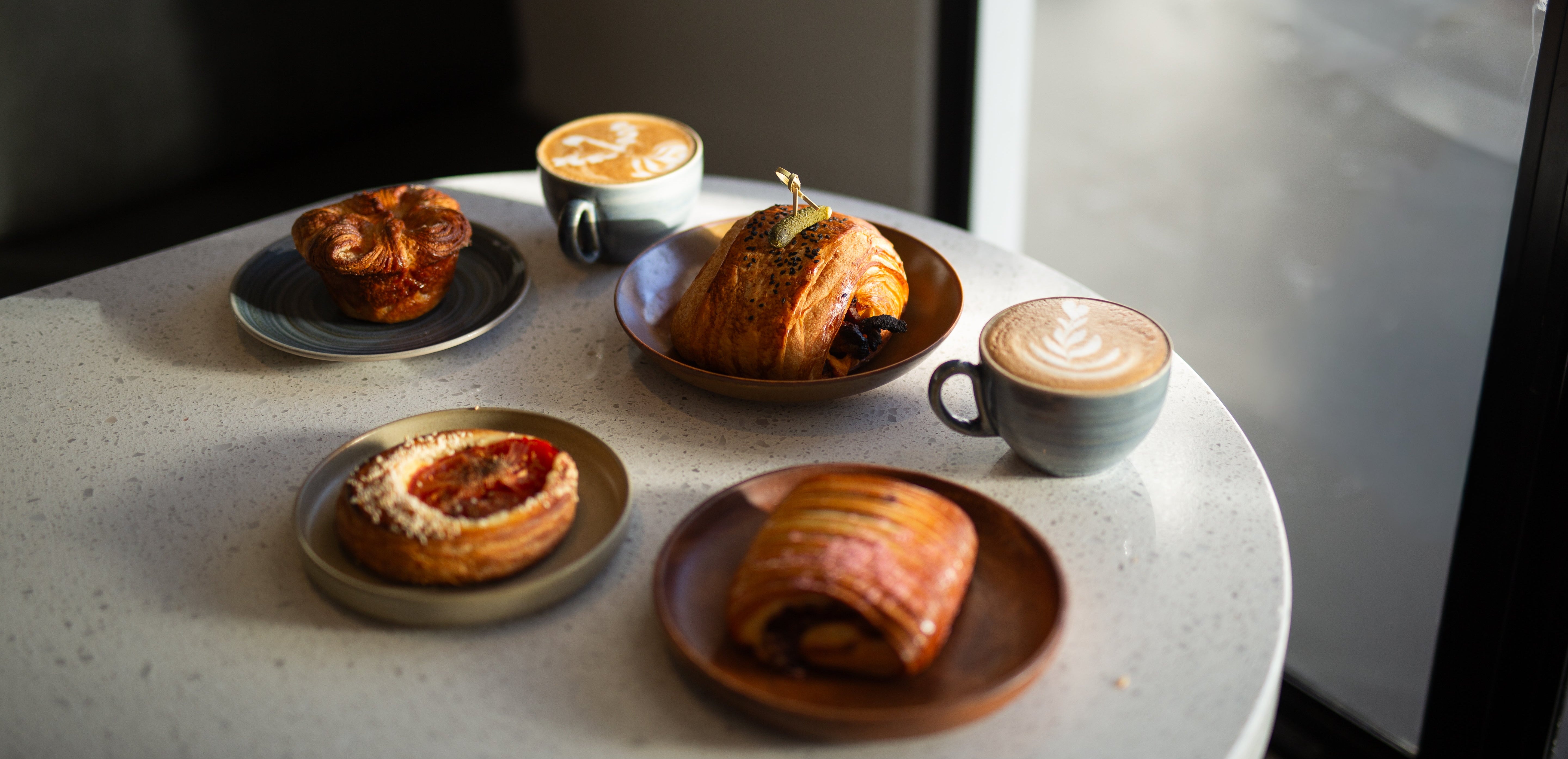 Pastries and lattes on the table at Bomou Artisanal Bakery