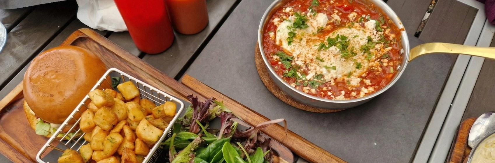 Shakshuka in a steel pan and a brunch board at Eggstatic Bayview